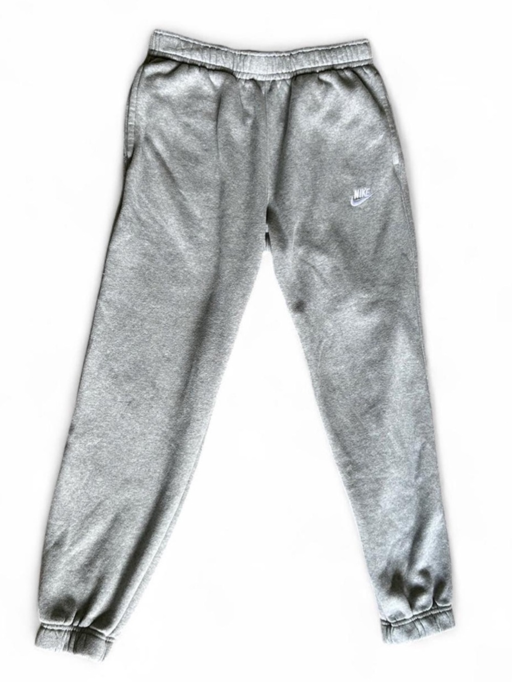 Grey Nike sweatpants with white embroidered logo. Women’s size Medium.